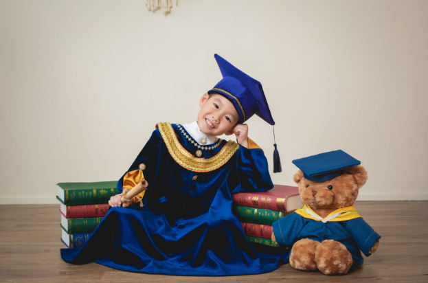 Pupil Graduation with Teddy Bear and Books