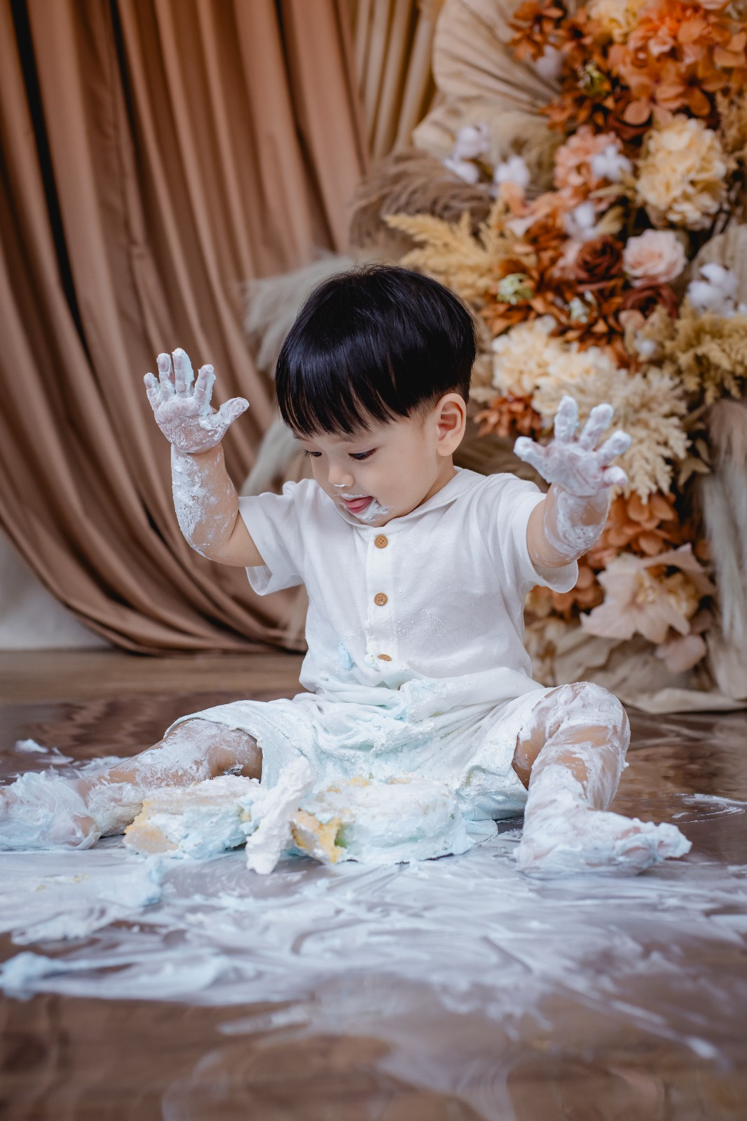 cake smash photoshoot showing playful cake mess and fun