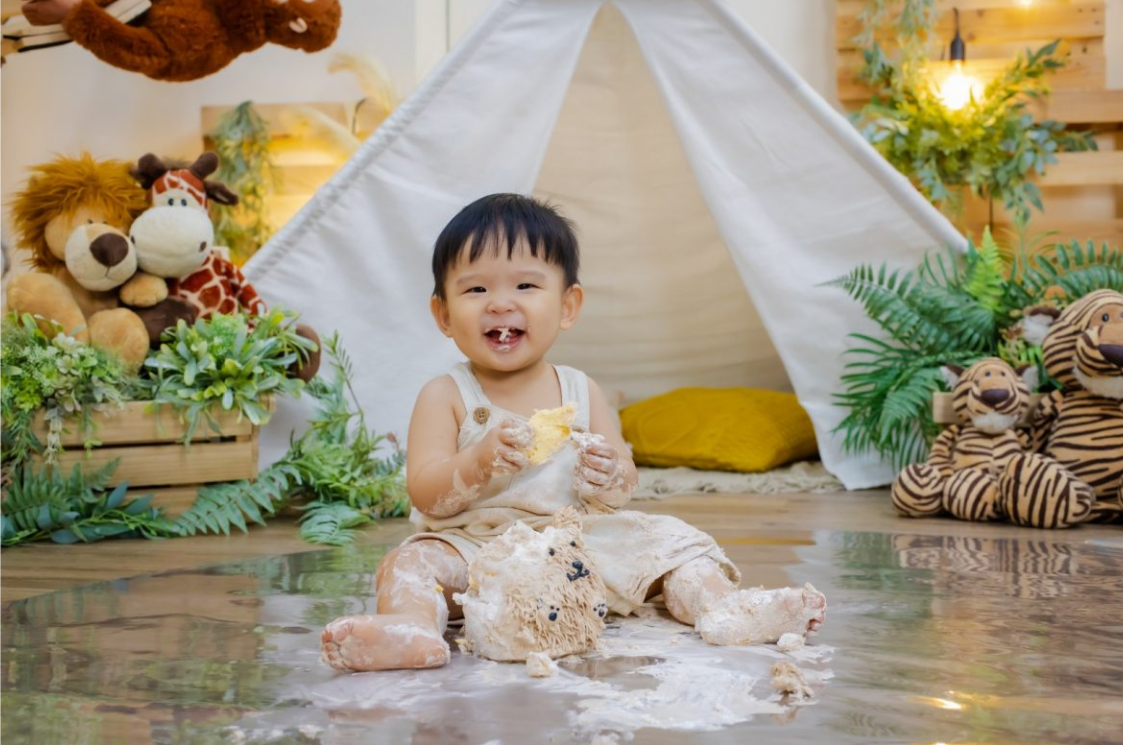 A baby eating a cake
