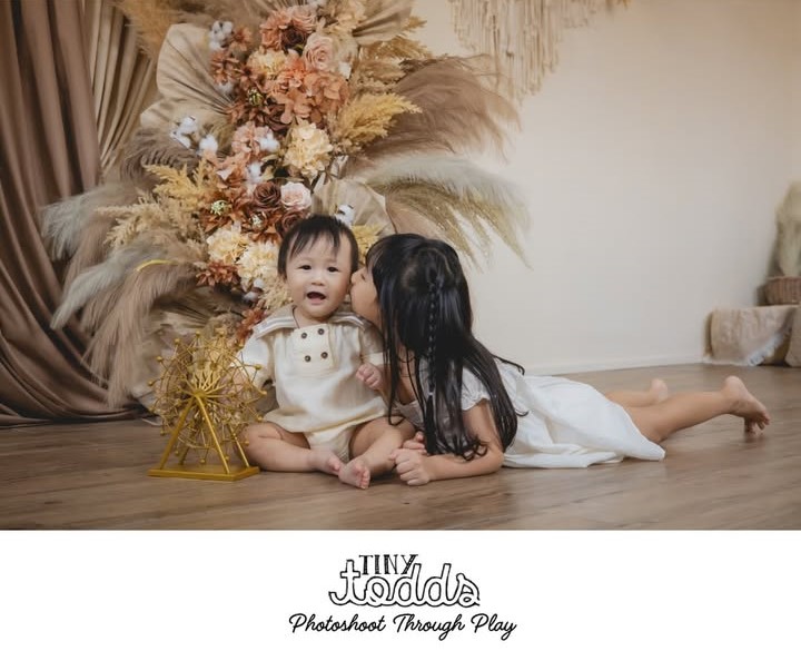 Siblings posing for a photoshoot.