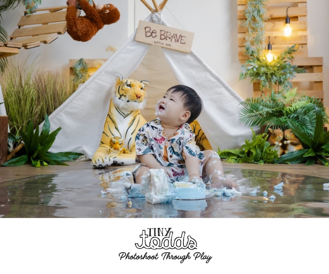 A baby smashing a cake.