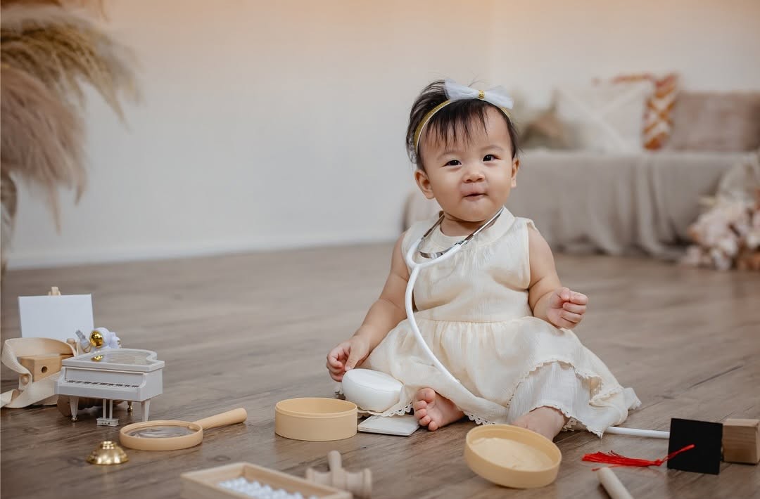Baby playing and sitting on the floor.